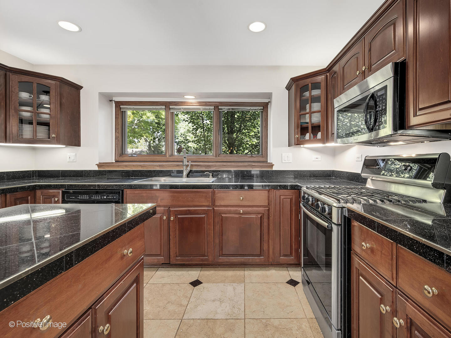 541 68th Street Willowbrook, IL 60527 - Photo 16 of 43 a kitchen with stainless steel appliances granite countertop a sink stove and microwave