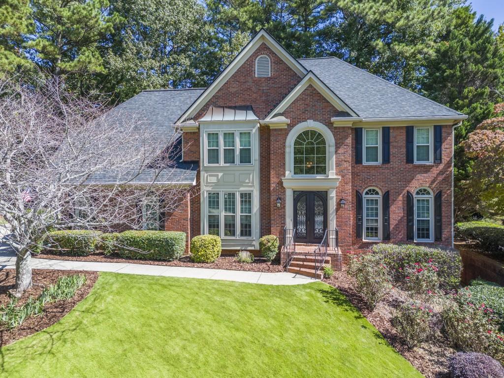 2275 Hamptons Crossing Alpharetta, GA 30005 - Photo 1 of 1 a front view of a house with yard and green space
