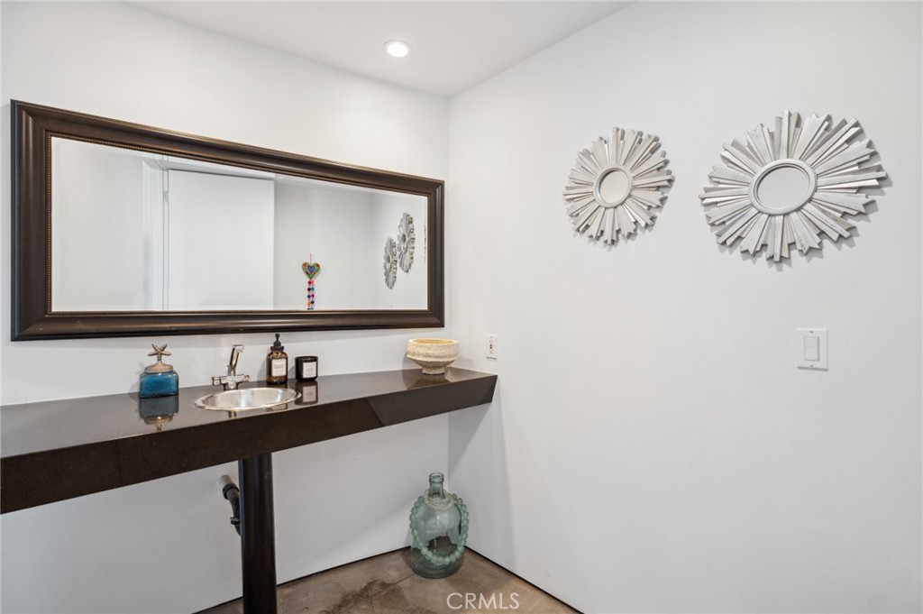 2831 Ridge Drive Laguna Beach, CA 92651 - Photo 20 of 21 a bathroom with a mirror and a sink