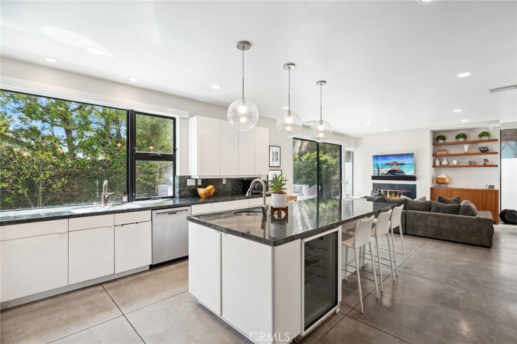 2831 Ridge Drive Laguna Beach, CA 92651 - Photo 8 of 21 a kitchen with stainless steel appliances granite countertop a sink and a wooden floors