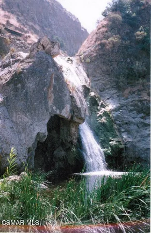 a view of outdoor with seating area and car parked