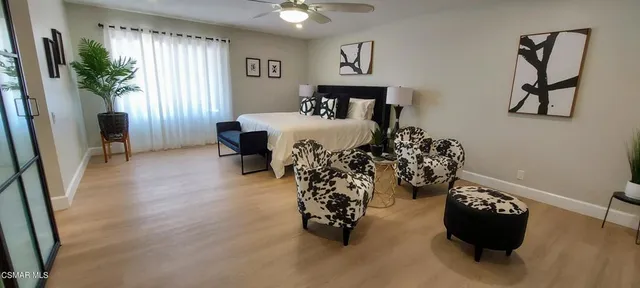 a bed room with a bed and a potted plant