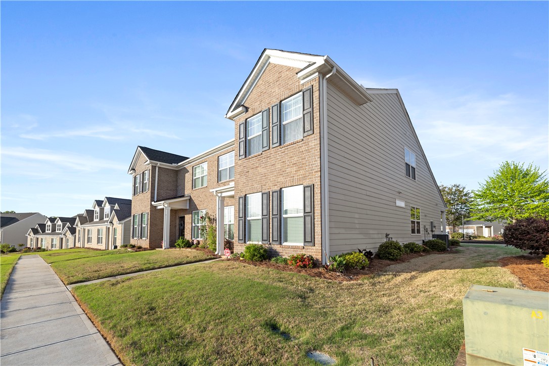 This charming residence features classic brick and siding, blending timeless elegance with modern comfort.