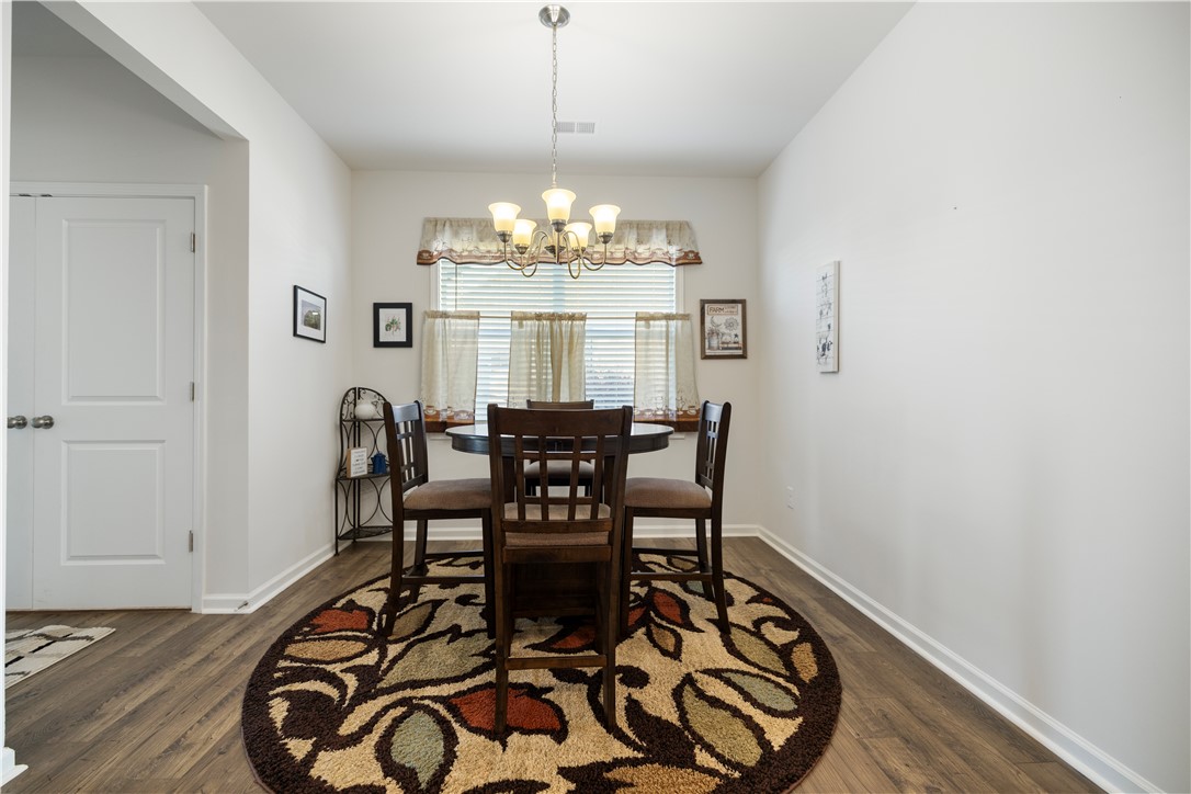 104 Village Main Anderson, SC 29621 - Photo 12 of 30 This cozy dining area features elegant hardwood flooring and natural light, perfect for intimate gatherings.