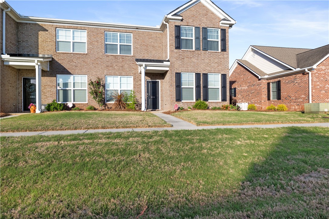 104 Village Main Anderson, SC 29621 - Photo 2 of 30 This classic brick townhome features an inviting entrance and well-maintained front yard.