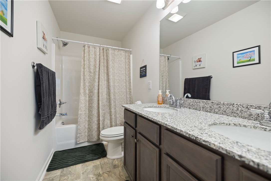 104 Village Main Anderson, SC 29621 - Photo 21 of 30 This bathroom features a double vanity and a shower-tub combination, creating a functional and practical space.