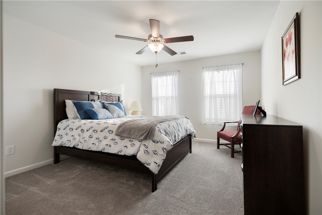 104 Village Main Anderson, SC 29621 - Photo 23 of 30 This serene bedroom offers abundant natural light and comfortable carpeted flooring for peaceful living.