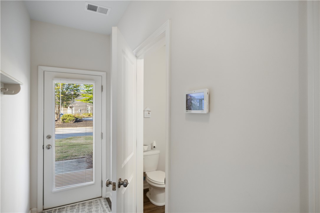 104 Village Main Anderson, SC 29621 - Photo 26 of 30 This bright entry features a glass-paneled door leading to a clean, well-appointed half-bath.
