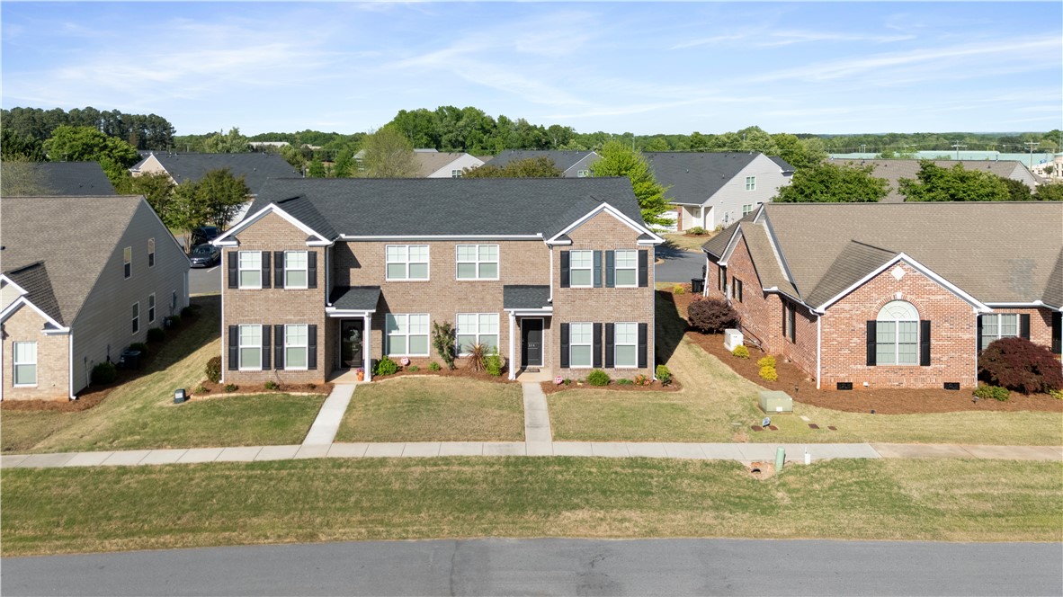 104 Village Main Anderson, SC 29621 - Photo 29 of 30 This charming neighborhood features traditional brick homes with well-maintained landscaping and sidewalks.