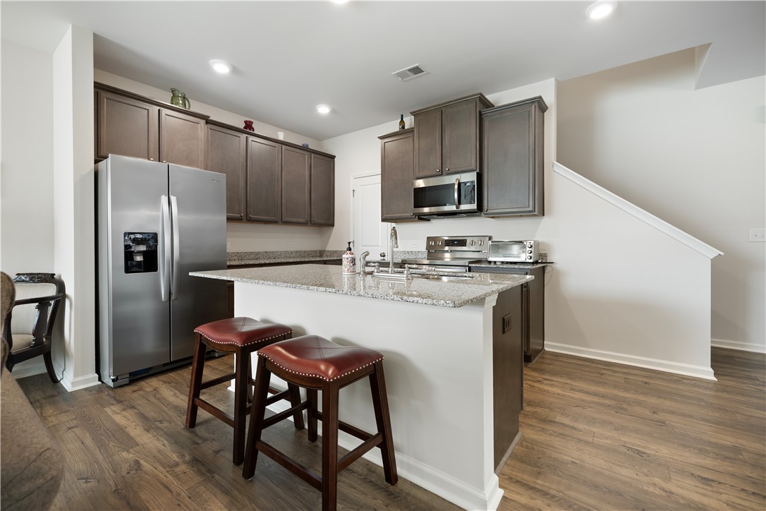 104 Village Main Anderson, SC 29621 - Photo 7 of 30 This functional kitchen features ample counter space and convenient island seating.