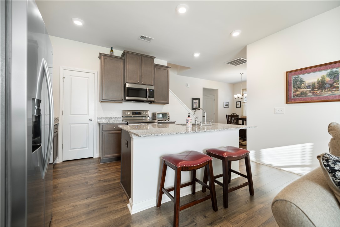 104 Village Main Anderson, SC 29621 - Photo 9 of 30 This modern kitchen features ample counter space, a central island, and contemporary appliances.