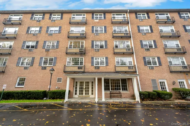 a front view of a residential apartment building with a yard