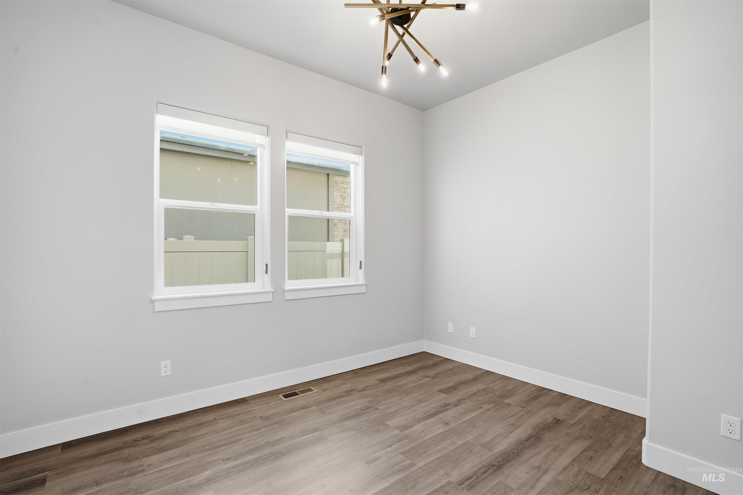 2976 East Parulo Drive Meridian, ID 83642 - Photo 29 of 40 Spare room featuring wood finished floors and baseboards