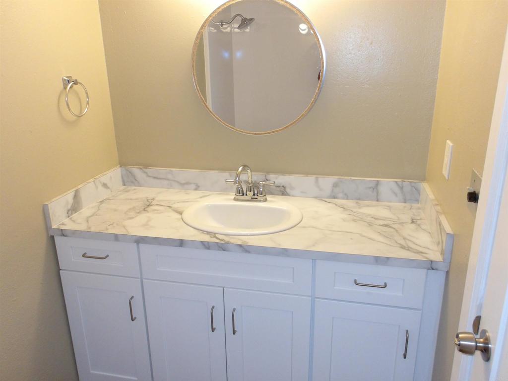 28857 Old Highway 80, Unit 3 Pine Valley, CA 91962 - Photo 4 of 15 a bathroom with a granite countertop sink and a mirror