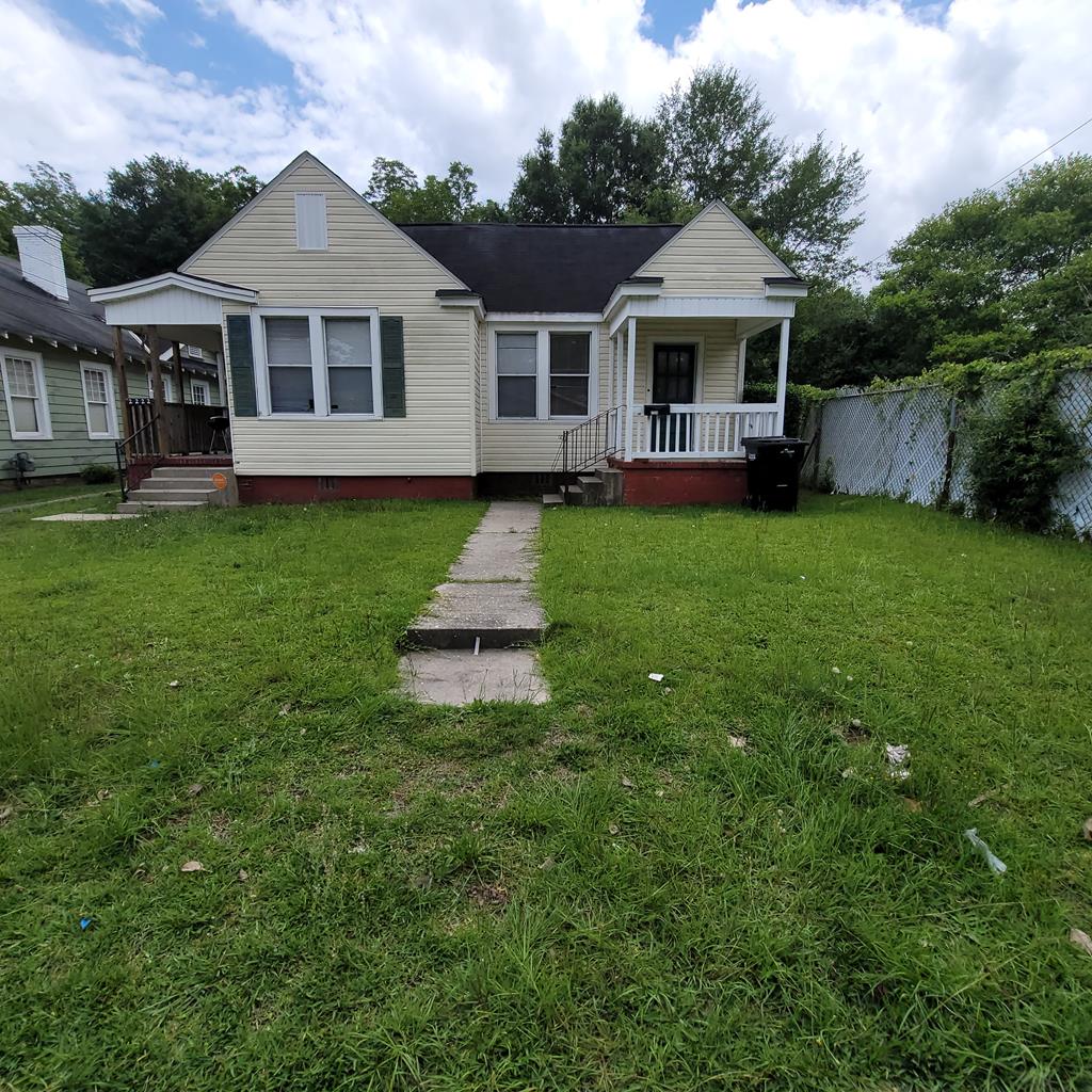 a front view of a house with a yard table and chairs