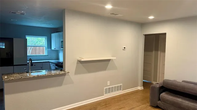 a living room with hard wood floors and a wooden floor