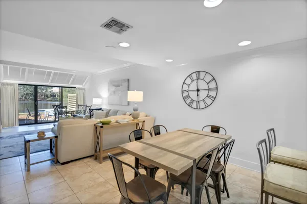 a dining room with furniture and a large window