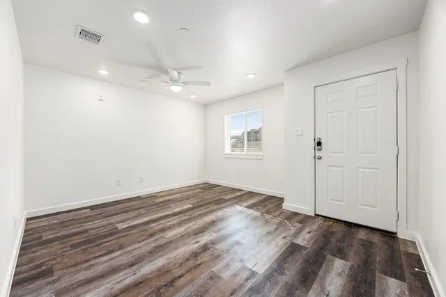 wooden floor in an empty room with a window