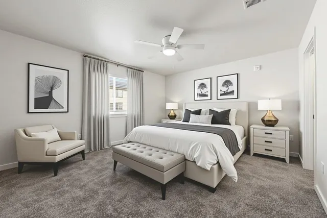 a spacious bedroom with a bed and a couch