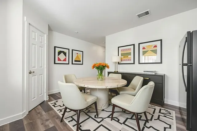 a dining room with furniture and window