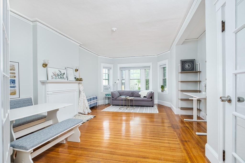108 Washington Street, Unit 8 Boston, MA 02135 - Photo 2 of 18 a living room with furniture and a wooden floor