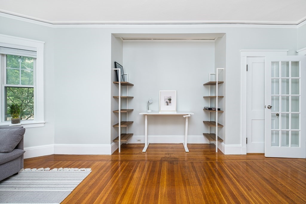 108 Washington Street, Unit 8 Boston, MA 02135 - Photo 4 of 18 a view of empty room with wooden floor and fan