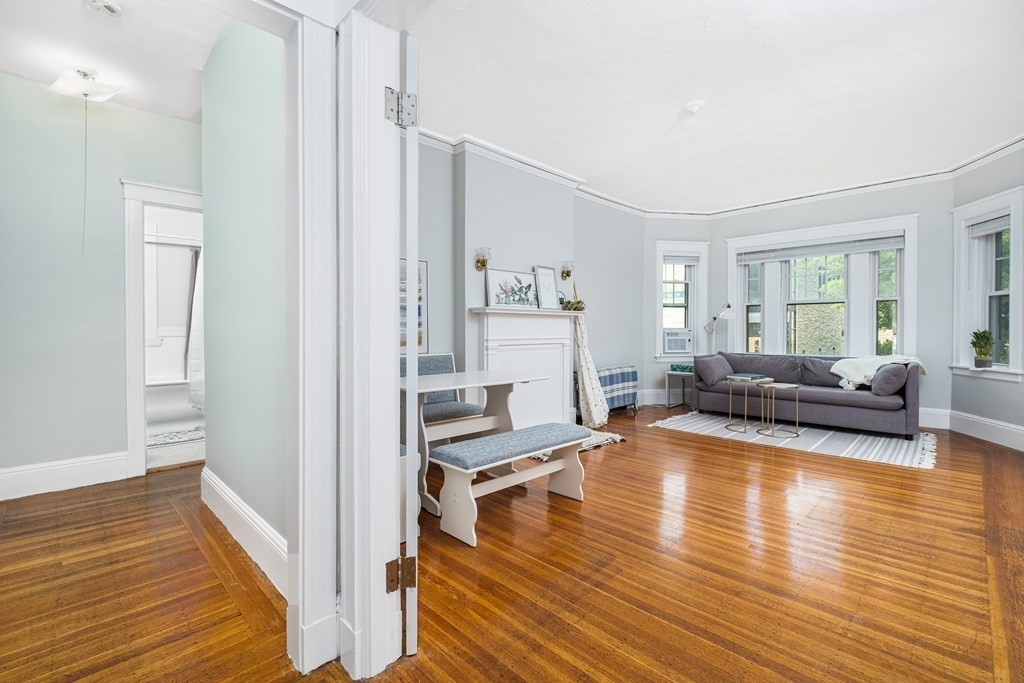 108 Washington Street, Unit 8 Boston, MA 02135 - Photo 5 of 18 a living room with furniture and a wooden floor
