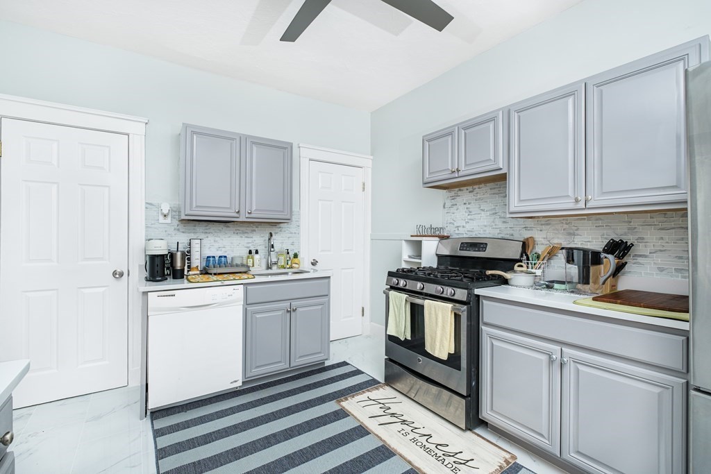 108 Washington Street, Unit 8 Boston, MA 02135 - Photo 9 of 18 a kitchen with stainless steel appliances granite countertop a sink and a stove
