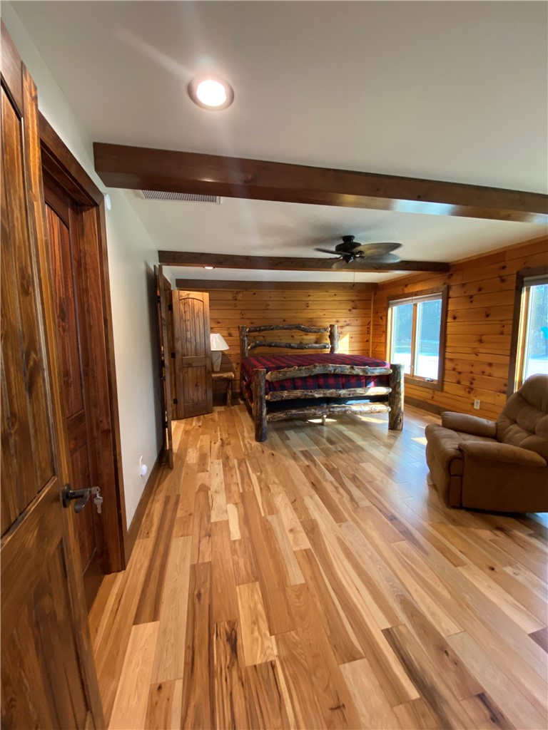128 McAlister Road West Union, SC 29696 - Photo 22 of 40 Natural wood flooring and exposed beams create a cozy retreat in this sun-filled bedroom.