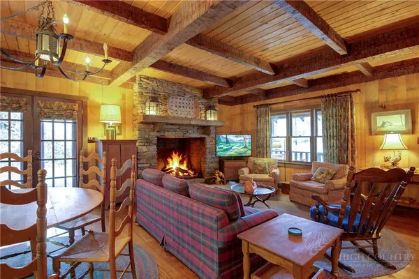 a living room with furniture a fireplace and a table