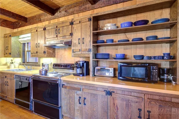 a kitchen with stainless steel appliances granite countertop a sink and cabinets