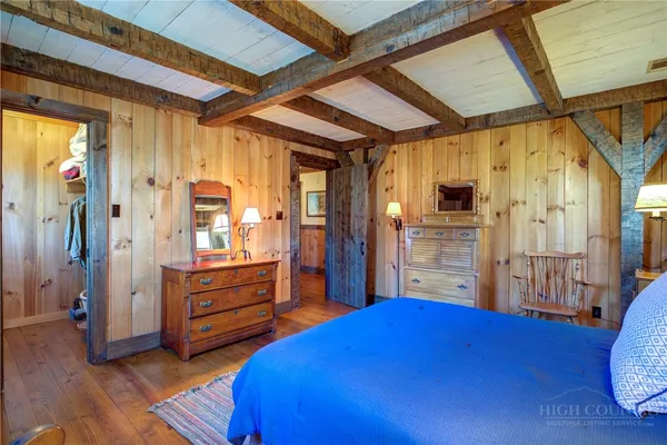a bedroom with furniture and a wooden floor
