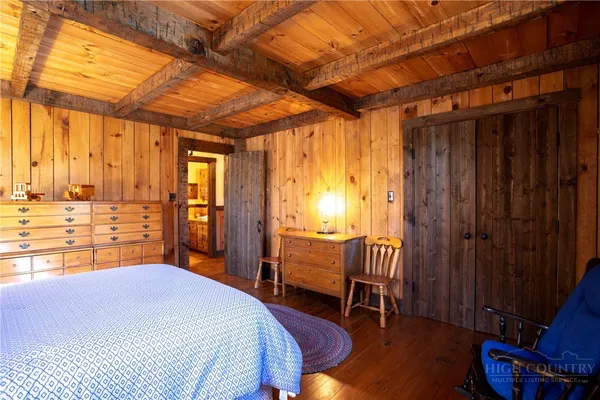 a bedroom with a bed and a chair