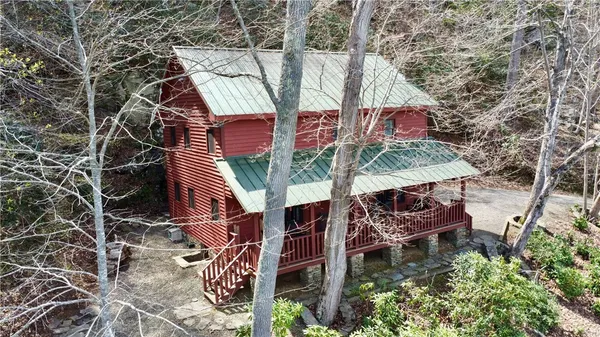 an aerial view of a house with balcony and outdoor space