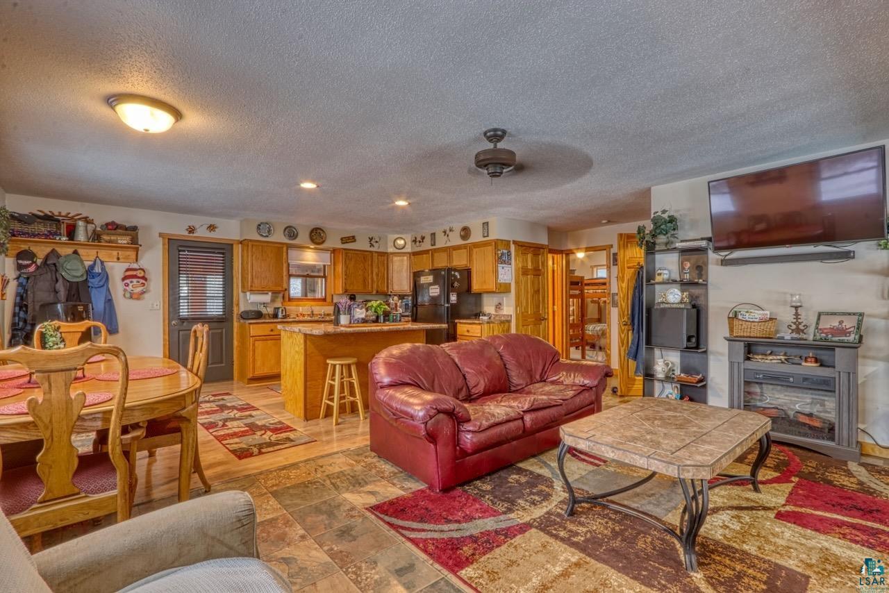 33469 No Mans Lake Road Minong, WI 54859 - Photo 16 of 38 Living room featuring a textured ceiling