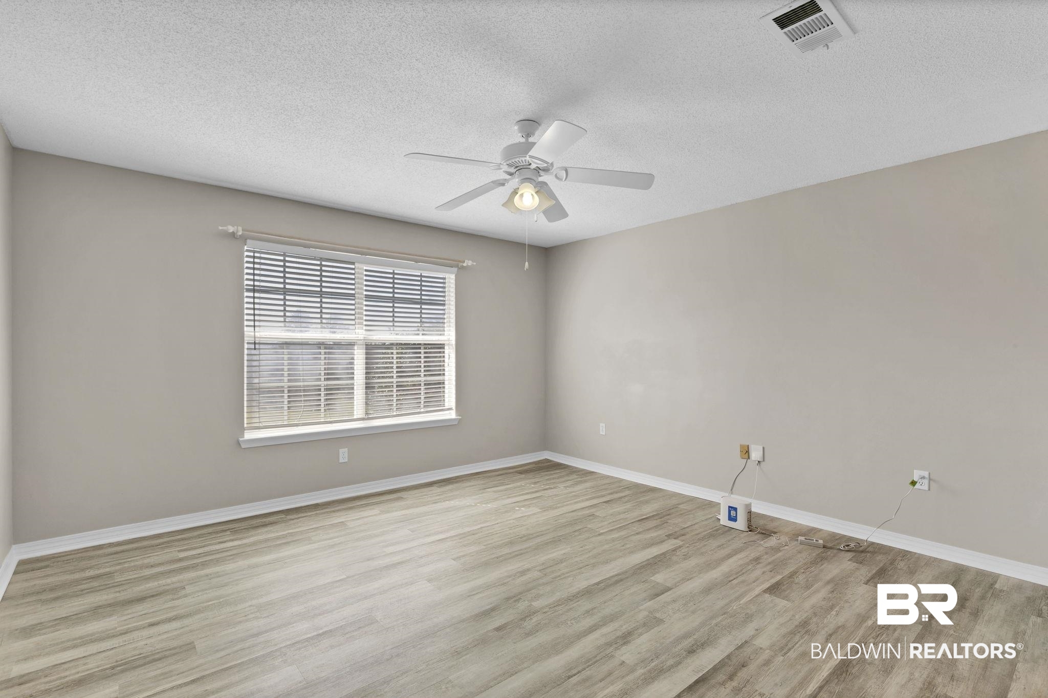10238 Grove Drive Fairhope, AL 36532 - Photo 25 of 39 Unfurnished room with a ceiling fan, and light wood finished floors