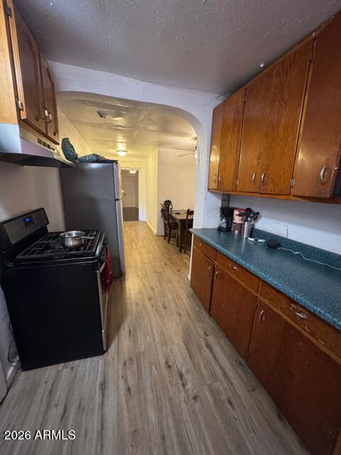 701 6th Green Street Douglas, AZ 85607 - Photo 3 of 10 a kitchen with a sink a stove and wooden floor