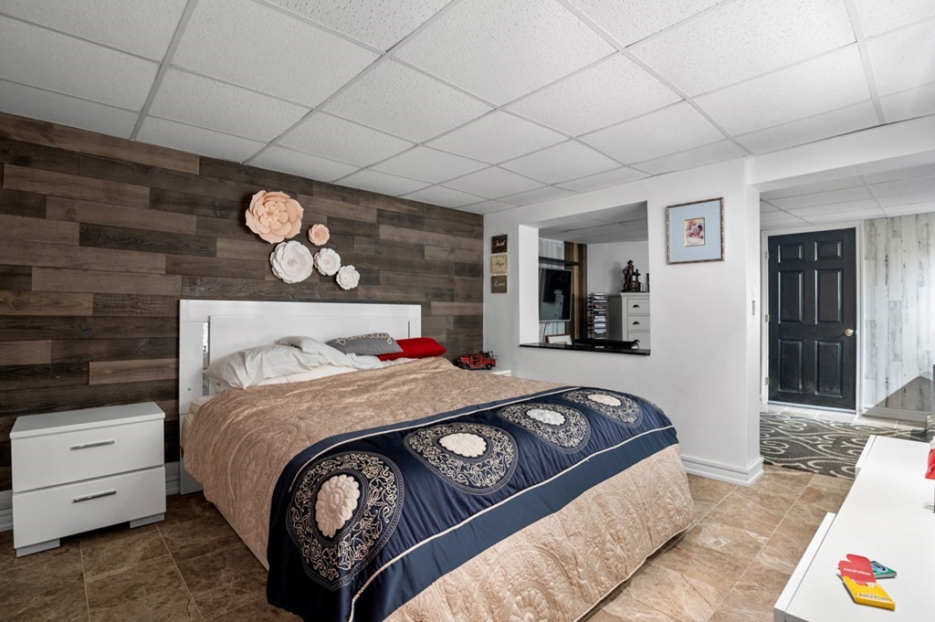 5 Michele Drive Salisbury, MA 01952 - Photo 12 of 38 a bedroom with a bed and a chandelier