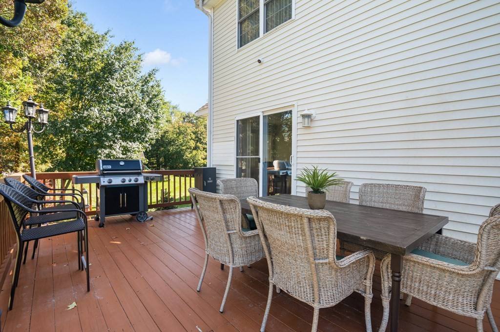 5 Michele Drive Salisbury, MA 01952 - Photo 15 of 38 a view of a deck with table and chairs and wooden floor