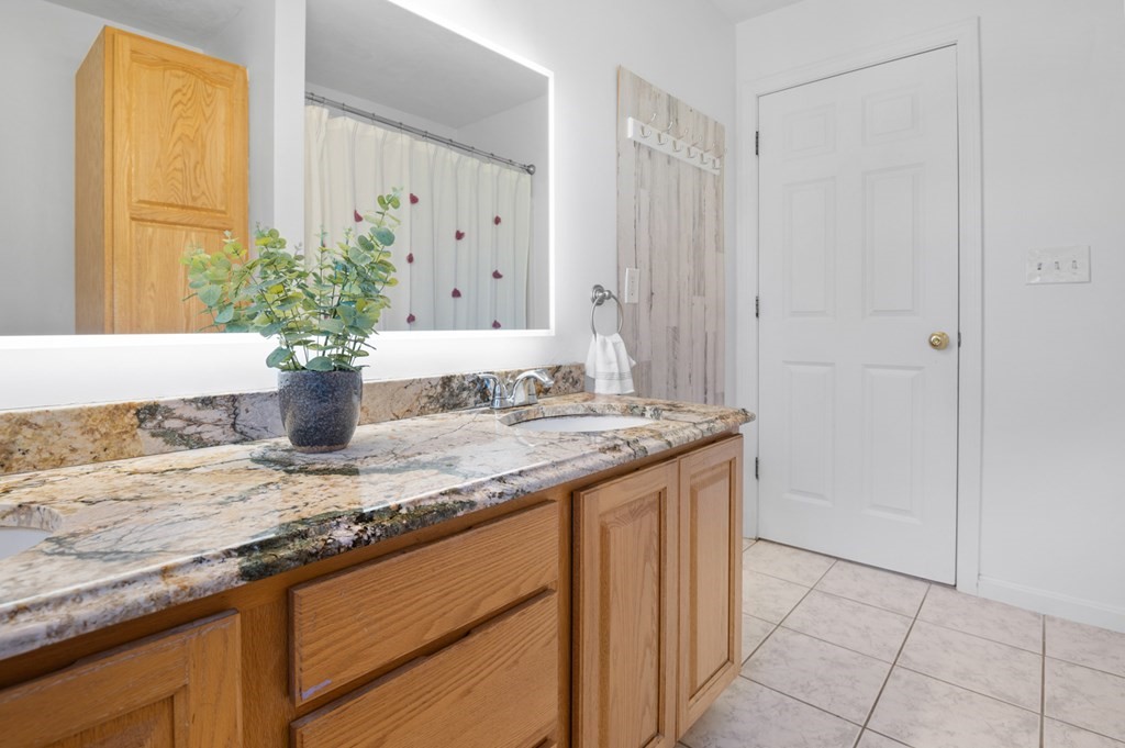 5 Michele Drive Salisbury, MA 01952 - Photo 20 of 38 a bathroom with a granite countertop sink and a mirror
