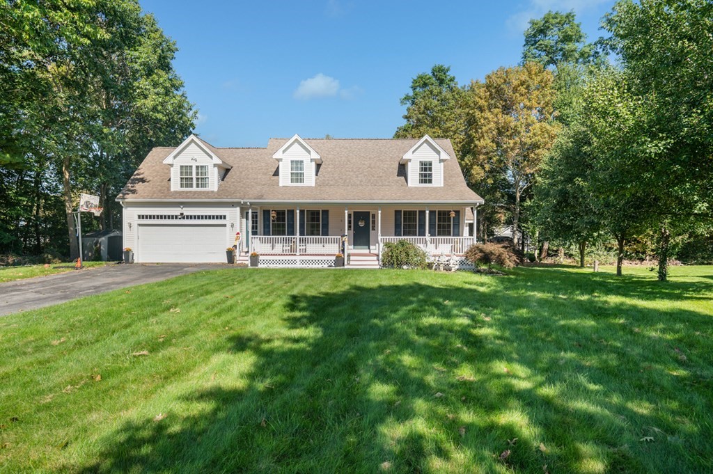 5 Michele Drive Salisbury, MA 01952 - Photo 2 of 38 a front view of a house with a garden and trees