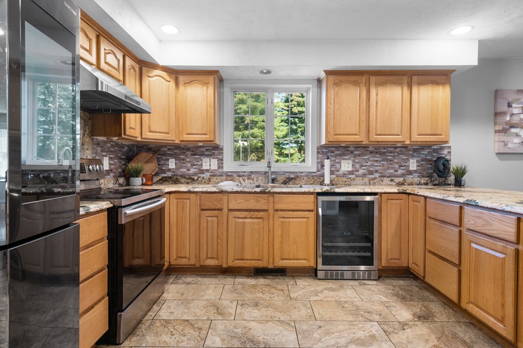 5 Michele Drive Salisbury, MA 01952 - Photo 33 of 38 a kitchen with stainless steel appliances granite countertop a sink stove and cabinets
