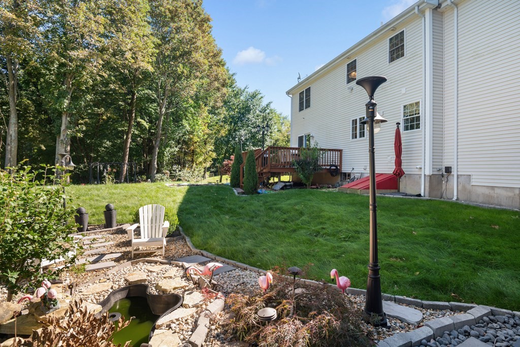5 Michele Drive Salisbury, MA 01952 - Photo 4 of 38 a view of a backyard with potted plants and a large tree