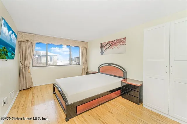 a bathroom with a granite countertop toilet sink and mirror