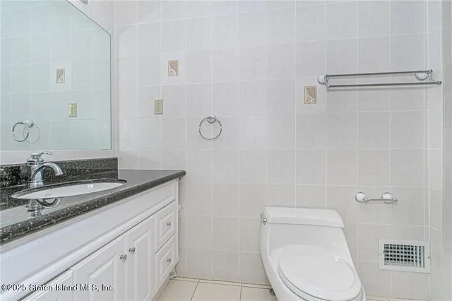 a view of a bedroom with wooden floor and cabinet