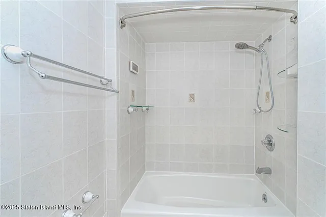 a bedroom with a bed and a shower