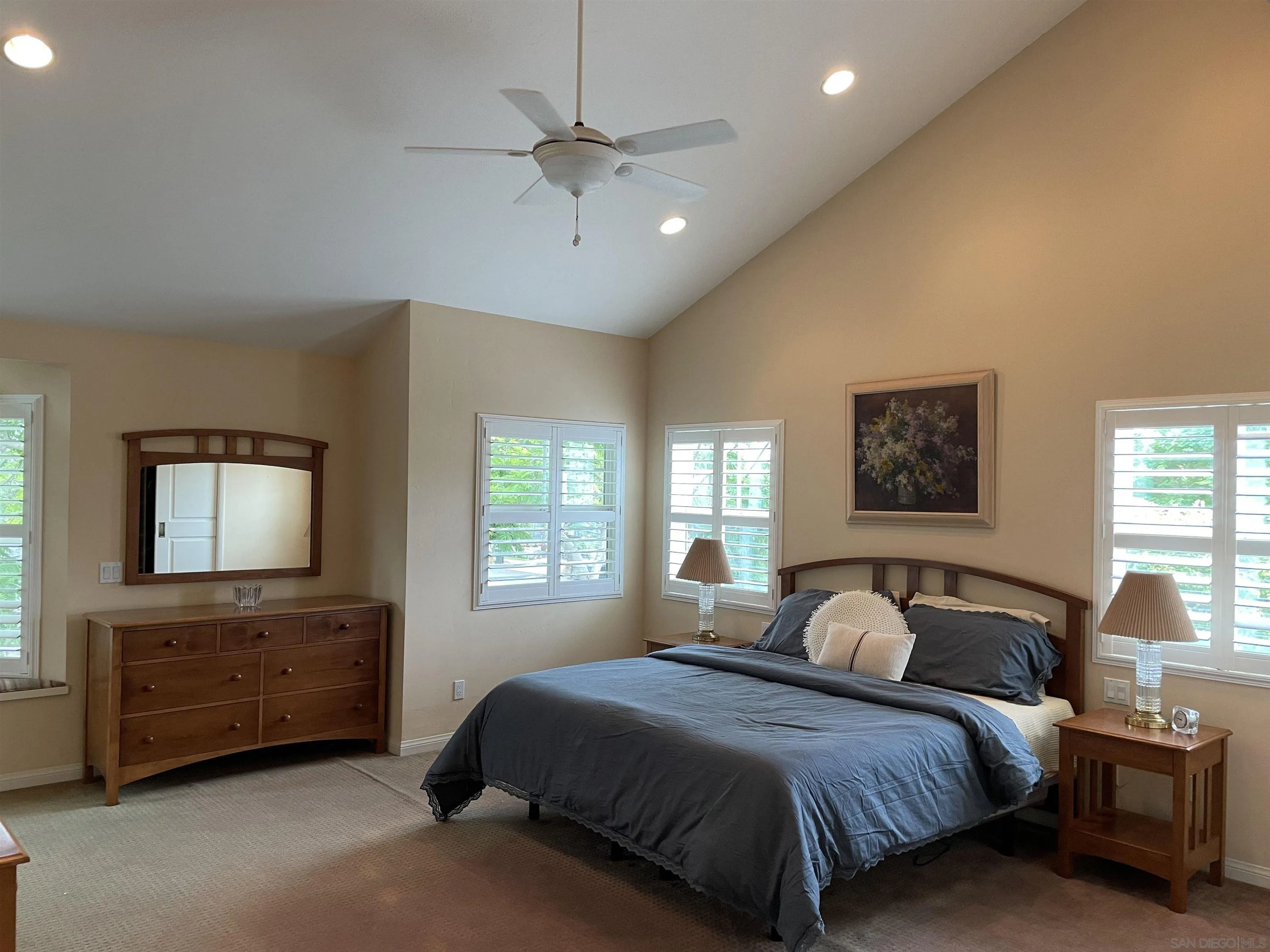 981 Cabrillo Avenue Coronado, CA 92118 - Photo 14 of 32 a spacious bedroom with a bed a chandelier and a window