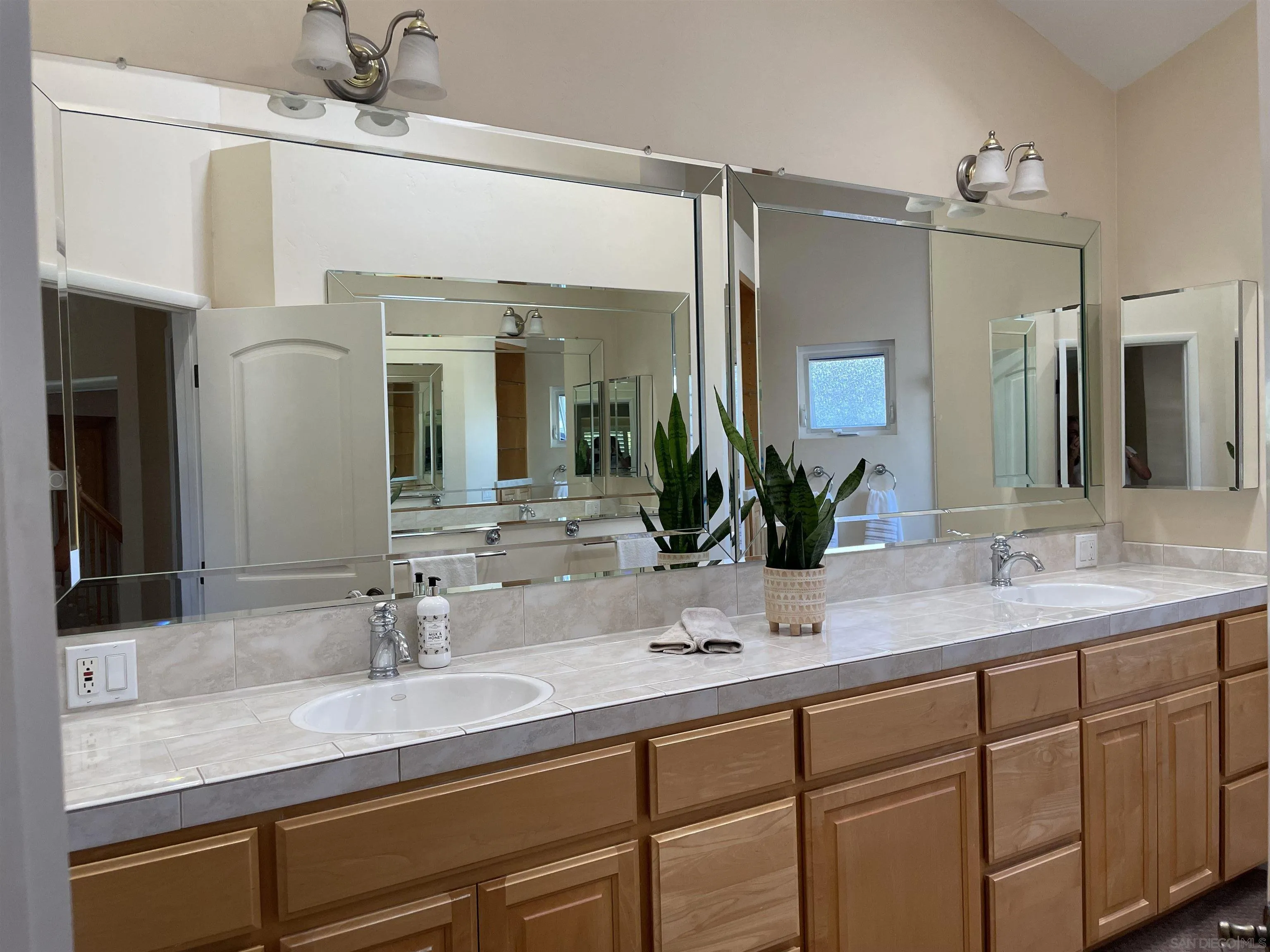 981 Cabrillo Avenue Coronado, CA 92118 - Photo 18 of 32 a bathroom with a sink double vanity and a mirror