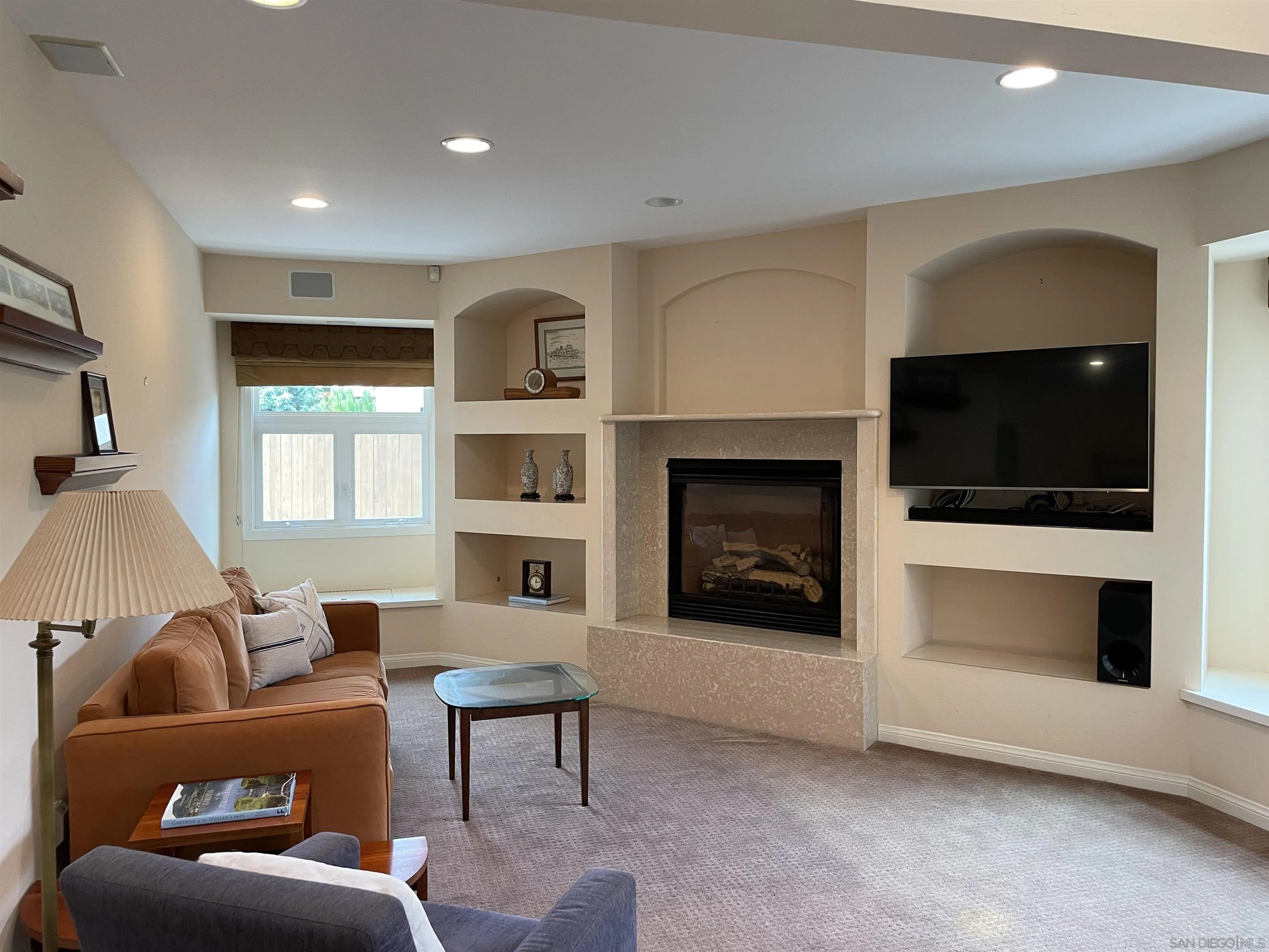 981 Cabrillo Avenue Coronado, CA 92118 - Photo 5 of 32 a living room with furniture a flat screen tv and a fireplace