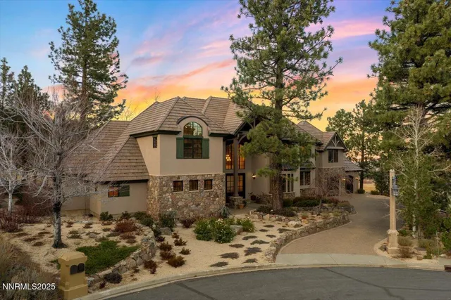 front view of a house with a tree